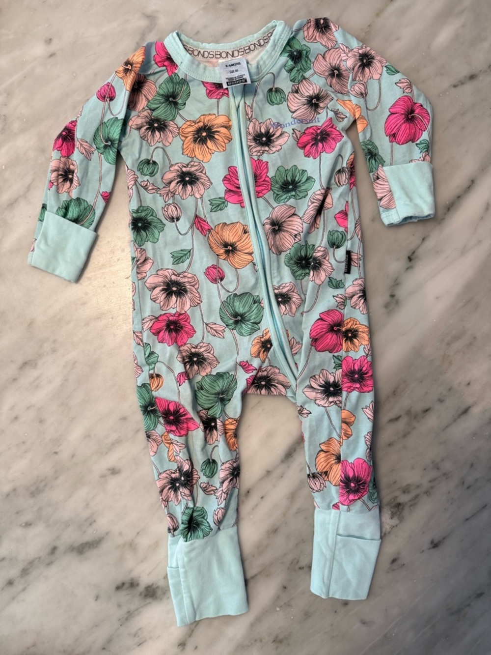 Bonds Wondersuit in light blue with flowers - size 00/ 3-6mo
